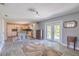 Open-concept kitchen features a center island, stainless steel appliances, and access to the backyard at 6909 Farris Dr, Lakeland, FL 33811