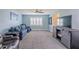 Cozy living room with a blue sofa, plantation shutters, and gray carpet at 6909 Farris Dr, Lakeland, FL 33811
