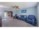 Living room with blue accent wall, gray carpet, and comfortable seating at 6909 Farris Dr, Lakeland, FL 33811
