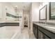 Luxurious bathroom featuring a soaking tub, a glass shower, and double vanities at 9349 Mira Valle Ln, Winter Garden, FL 34787