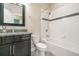 A bathroom featuring a granite vanity, and a shower/tub combo with decorative tile at 9349 Mira Valle Ln, Winter Garden, FL 34787