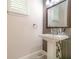 Stylish half-bathroom features a pedestal sink and modern tiled accent wall at 9349 Mira Valle Ln, Winter Garden, FL 34787
