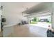 A large garage with an open door showcasing the driveway and the exterior of the home at 9349 Mira Valle Ln, Winter Garden, FL 34787