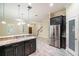 Open kitchen boasts stainless steel appliances, granite countertops, and a pantry for storage at 9349 Mira Valle Ln, Winter Garden, FL 34787