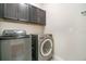 Laundry area with front loading washer and dryer, and ample cabinets for storage at 9349 Mira Valle Ln, Winter Garden, FL 34787