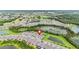 Aerial view of a residential area, with pond, landscaping and golf course in the background at 2132 Limestone Trl, Kissimmee, FL 34747