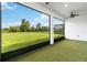 View of the expansive backyard through the sliding doors of the enclosed patio at 2132 Limestone Trl, Kissimmee, FL 34747