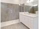 Modern bathroom featuring granite countertop vanity and tiled walk-in shower at 2132 Limestone Trl, Kissimmee, FL 34747