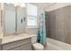 Bathroom featuring a vanity with granite countertop and tiled tub and shower at 2132 Limestone Trl, Kissimmee, FL 34747