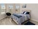 Bright bedroom features a large window with outdoor views and chair at 2132 Limestone Trl, Kissimmee, FL 34747