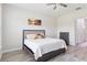 Bedroom showcasing neutral tones, wood-look tile flooring, and ceiling fan at 2132 Limestone Trl, Kissimmee, FL 34747
