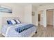 Inviting bedroom featuring coastal-themed decor, wood-look tile, and access to the bathroom at 2132 Limestone Trl, Kissimmee, FL 34747