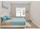Bright bedroom with white wood floors, a white wood bed, and blue decorations at 2132 Limestone Trl, Kissimmee, FL 34747