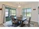 Dining room with a rustic wood table, stylish chairs, and views of the outdoor space at 2132 Limestone Trl, Kissimmee, FL 34747