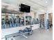 Modern gym featuring a variety of fitness equipment and mirrored wall for a comprehensive workout experience at 2132 Limestone Trl, Kissimmee, FL 34747