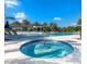 Enjoy this community hot tub with a large pool and surrounding palm trees under sunny skies at 2132 Limestone Trl, Kissimmee, FL 34747