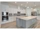 Modern kitchen with stainless steel appliances, a large island, and white cabinetry at 2132 Limestone Trl, Kissimmee, FL 34747