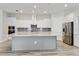 Modern kitchen with stainless steel appliances, a large island, and white cabinetry at 2132 Limestone Trl, Kissimmee, FL 34747