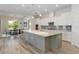 Open-concept kitchen with a large island, stainless steel appliances, and adjacent dining area at 2132 Limestone Trl, Kissimmee, FL 34747