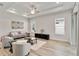 Cozy living room with tile flooring, a tray ceiling, and neutral-toned furniture at 2132 Limestone Trl, Kissimmee, FL 34747