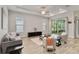 Bright living room featuring neutral tones, wood-look tile flooring, and sliding glass doors to outdoor space at 2132 Limestone Trl, Kissimmee, FL 34747