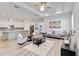 Open living room featuring tile flooring, modern furniture, and seamless access to the kitchen at 2132 Limestone Trl, Kissimmee, FL 34747