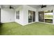 Enclosed patio with artificial grass and multiple sliding doors for outdoor relaxation at 2132 Limestone Trl, Kissimmee, FL 34747