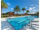 A community lap pool surrounded by lounge chairs and green space, ideal for relaxation and recreation at 2132 Limestone Trl, Kissimmee, FL 34747