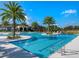 Resort-style pool with ample deck space, palm trees and clubhouse for an exceptional outdoor experience at 2132 Limestone Trl, Kissimmee, FL 34747