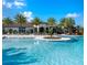 Resort-style pool with ample deck space, palm trees and clubhouse for an exceptional outdoor experience at 2132 Limestone Trl, Kissimmee, FL 34747