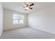 A bedroom with gray carpet, a ceiling fan, and a window with blinds at 3079 Bethpage Loop, Mount Dora, FL 32757