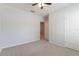 Clean bedroom featuring neutral walls, plush carpeting, and a bright window with natural light at 3079 Bethpage Loop, Mount Dora, FL 32757