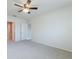 A bedroom with gray carpet, a ceiling fan, and neutral paint at 3079 Bethpage Loop, Mount Dora, FL 32757