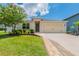 Charming single-Gathering home featuring a well-manicured lawn and inviting walkway leading to the front door at 3079 Bethpage Loop, Mount Dora, FL 32757