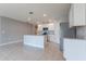 Bright kitchen with stainless steel appliances, white cabinets, and a granite island for ample counter space at 3079 Bethpage Loop, Mount Dora, FL 32757