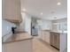 Modern kitchen features stainless steel appliances, granite countertops, and a view of the breakfast nook at 3079 Bethpage Loop, Mount Dora, FL 32757