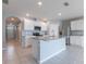 Open kitchen featuring an island, stainless steel appliances, granite countertops and white cabinets at 3079 Bethpage Loop, Mount Dora, FL 32757