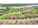 An aerial view showcases the single-Gathering homes and landscaping in this well-maintained community at 4235 Prima Lago Dr, Lakeland, FL 33810