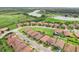 Aerial view showcasing the community's single-Gathering homes with well-maintained landscaping, ponds and green spaces at 4235 Prima Lago Dr, Lakeland, FL 33810