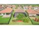 Aerial view of a home with a large screened patio and lush backyard, nestled in a neighborhood of similar homes at 4235 Prima Lago Dr, Lakeland, FL 33810