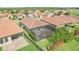 Aerial shot showcasing the home's backyard with a screened patio and well-maintained landscaping within a fenced perimeter at 4235 Prima Lago Dr, Lakeland, FL 33810