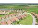 An aerial view displays the neighborhood's single-Gathering homes, manicured lawns, ponds, and green areas at 4235 Prima Lago Dr, Lakeland, FL 33810