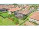 Aerial view of a cozy home with a screened patio, surrounded by well-kept lawns and neighboring residences at 4235 Prima Lago Dr, Lakeland, FL 33810