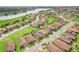 An aerial view shows the community with landscaped lawns, ponds, and lush green spaces surrounding the houses at 4235 Prima Lago Dr, Lakeland, FL 33810