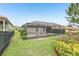 Backyard featuring grass, plants and a screened in patio at 4235 Prima Lago Dr, Lakeland, FL 33810