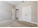 Bedroom with carpet, neutral paint, double doors, and closet space at 4235 Prima Lago Dr, Lakeland, FL 33810