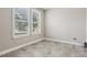 This bedroom features tile flooring, plantation shutters, and neutral paint at 4235 Prima Lago Dr, Lakeland, FL 33810
