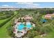Aerial view of community pool, spa, and deck with lounge chairs and landscaping at 4235 Prima Lago Dr, Lakeland, FL 33810