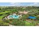 Aerial shot of a community pool, sunshades, and recreational areas amid lush landscaping at 4235 Prima Lago Dr, Lakeland, FL 33810
