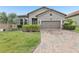 Beautiful home featuring well-maintained landscaping and a brick driveway at 4235 Prima Lago Dr, Lakeland, FL 33810